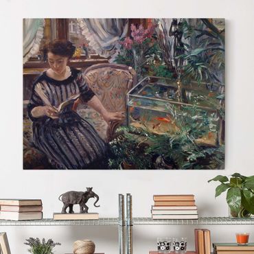Canvas schilderijen Lovis Corinth - A Woman Reading Near A Goldfish Tank